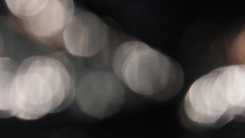 Full screen crystal bokeh light circles flaring video on black background 스톡 동영상 317482090