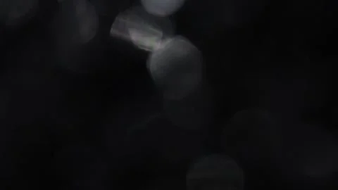 Full screen white bokeh lights flickering on black background Stock Footage 317478668