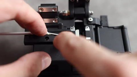 The full shot of cable insertion and precise fiber cut Stockbeeldmateriaal 312358672