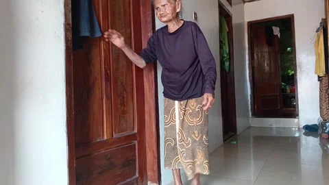 Full shot to close-up of a very old Indonesian. Stock Footage 318601698