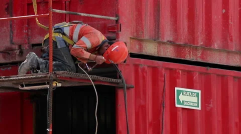 FULL SHOT-HANDHELD.  Construction workers  on his knees using a tool. Stock Footage 41119789