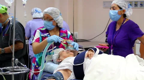 FULL SHOT-HANDHELD SHOT. Surgery team preparing a patient for surgery. Stock Footage 45026675