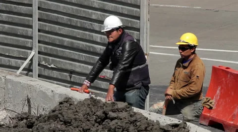 FULL SHOT-HANDHELD. Two construction workers resting a moment. Stock Footage 41117180