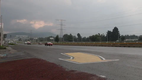 Full shot of a highway on a cloudy day, several cars pass in front of the camera Stock Footage 138861211