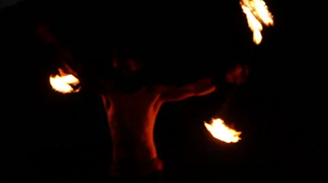 FULL SHOT. Man doing fire juggling in the beach in front to the sea at night. Stock Footage 49758492