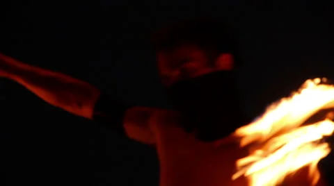 FULL SHOT. Man doing fire juggling in the beach in front to the sea at night. Stock Footage 49758933