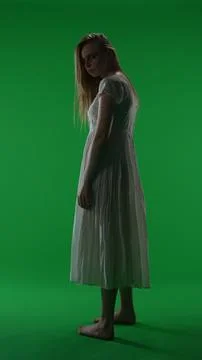 Full-size half turn vertical green screen, chroma key shot of a posessed female Stock Photos