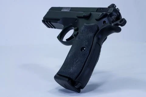Full-size handgun displayed on a table with a cocked  hammer ready to shoot. Stock Photos