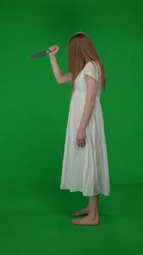 Full-size side view vertical green screen, chroma key shot of a posessed female Foto stock