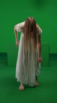 Full-size vertical green screen, chroma key shot of a posessed female, woman Fotos de archivo