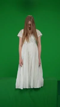 Full-size vertical green screen, chroma key shot of a posessed female, woman 스톡 사진