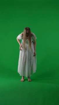 Full-size vertical green screen, chroma key shot of a posessed female, woman Foto stock