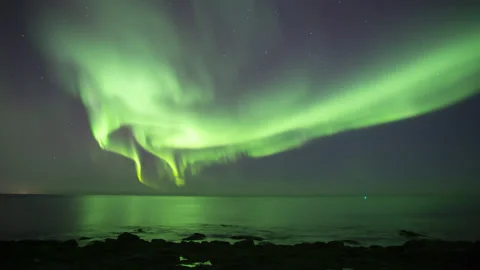 Full sky bright aurora borealis reflecting in ocean Iceland Stock Footage 146866865
