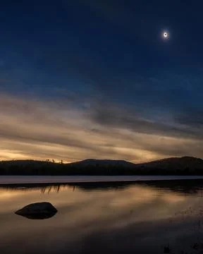Full Solar Eclipse over lake Stock Photos