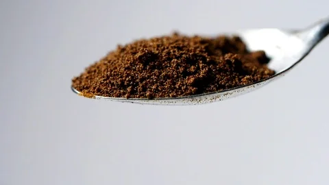 A full spoon of coffee. Coffee powder falling in slow motion from spoon Stock Footage 113595877