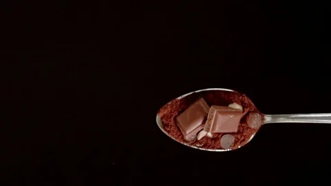 A Full Spoon Of exotic spice Flying up and Falling down on black background  Stock Footage 121429941