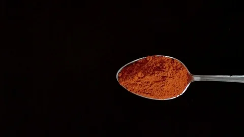 A Full Spoon Of exotic spice paprika Flying up and Falling down super slow  mo 스톡 동영상 121430153