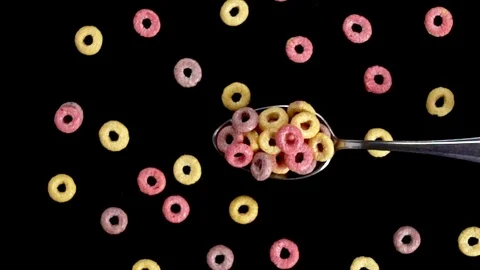 A Full Spoon Of froot loops Flying up and Falling down on black background  스톡 동영상 121429412
