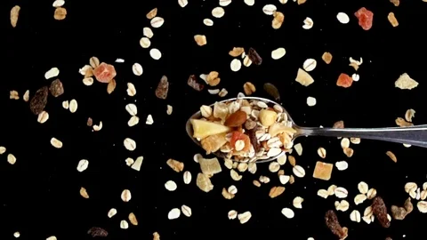 A Full Spoon Of fruit cereals  Flying up and Falling down on black background cl Video stock 121427545