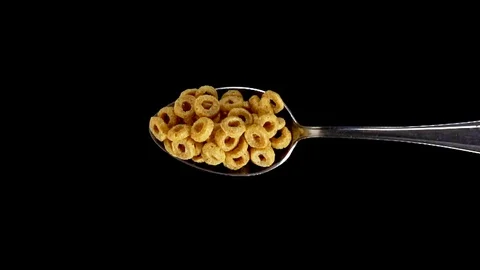 A Full Spoon Of honey rings falling down on black background super slow mo Stock Footage 121431887