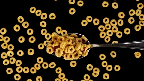 A Full Spoon Of honey rings falling down on black background super slow mo Stock Footage 121432203