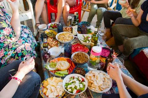 Full table view, people hands and eating process. Friends at the table eating Stock Photos