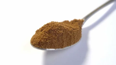 A full teaspoon of dry instant chicory root powder on a white background. Mac Stock Footage 178415965