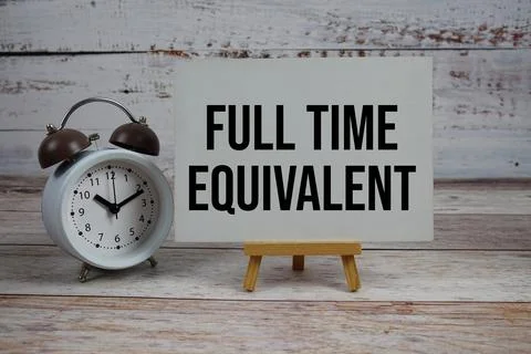 Full Time Equivalent text with easel and alarm clock on wooden background Stock Photos