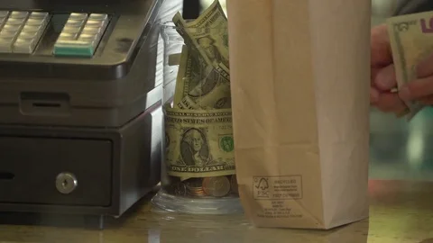 A full tip jar near register Stock Footage 73890602