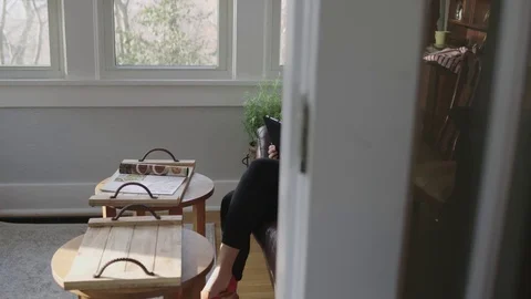 Full tracking shot of a young lady working on a tablet engaged in content Stock Footage 70808969