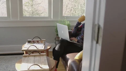 Full tracking shot of a young lady working on a laptop Stock Footage 70808997