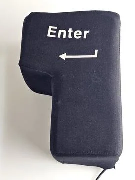 Full View of Giant Soft Enter Key on White Background Stock Photos