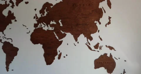 Full view of wooden world map inside modern room with white background Stock Footage 230490113