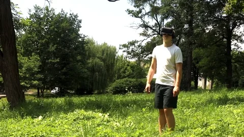 Full view of young caucasian man watching virtual reality with VR glasses headse Видео 116795934