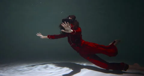 Full virtual reality experience. Young beautiful woman in red pyjamas using VR Stock Footage 153878601