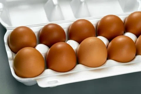 Full white container box of farm fresh brown chicken eggs. Stock Photos