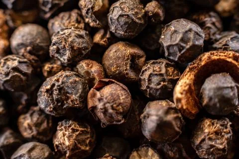 Fullscreen macro closeup with shallow depth of field of unmilled black pepper Stock Photos