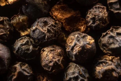 Fullscreen macro closeup with shallow depth of field of unmilled black pepper Stock Photos