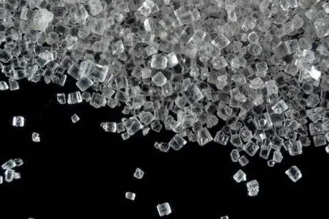 Fullscreen macro closeup with shallow depth of field of small sugar grains on Stock Photos