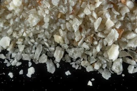 Fullscreen macro closeup with shallow depth of field of breadcrumbs on a blac Stock Photos