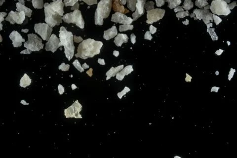 Fullscreen macro closeup with shallow depth of field of breadcrumbs on a blac Stock Photos