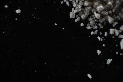 Fullscreen macro closeup with shallow depth of field of breadcrumbs on a blac Stock Photos