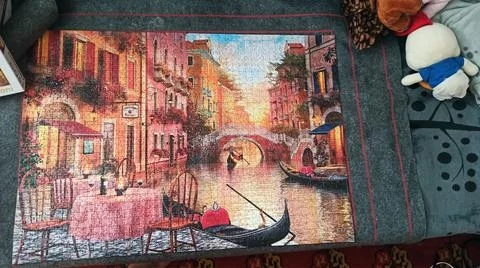 A fully completed jigsaw puzzle block of an image of venice, Italy on a carpe Stock Photos