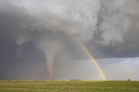 Fully Condensed Tornado with a Rainbow. a rotating column of air reaching t.. Stock Photos