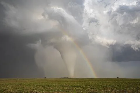 Fully Condensed Tornado with a Rainbow, a spiralling column of air reaching.. Stock Photos