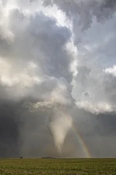 Fully Condensed Tornado with a Rainbow, a spiralling column of air reaching.. Stock Photos