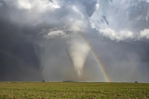 Fully Condensed Tornado with a Rainbow, a spiralling column of air reaching.. Stock Photos
