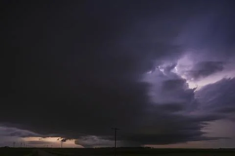 Fully Developed Wedge Tornado on the Ground after Sunset with  Lightning in.. Stock Photos