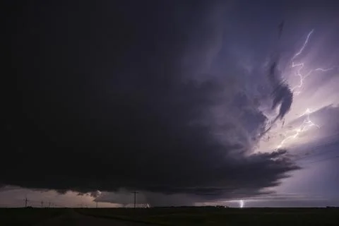 Fully Developed Wedge Tornado on the Ground after Sunset with  Lightning in.. Stock Photos