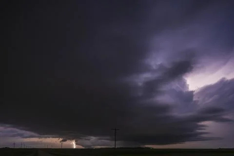 Fully Developed Wedge Tornado on the Ground after Sunset with  Lightning in.. Stock Photos